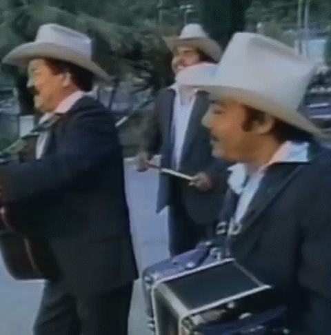 A Group Of Men Wearing Cowboy Hats And Suits Are Playing Instruments GIF