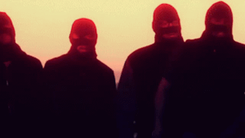 A Group Of Men Wearing Ski Masks Stand In A Row GIF
