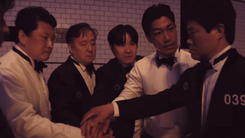 A Group Of Men Wearing Tuxedos And Bow Ties With The Number 036 On Their Chests GIF