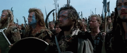 Men With Blue Paint Holding Swords And Shields GIF