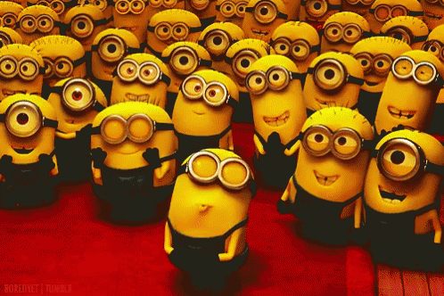 a group of minions are gathered together and one of them is wearing sunglasses