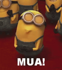 A Group Of Minions Are Standing Next To Each Other And One Of Them Is Smiling And Says Mua GIF