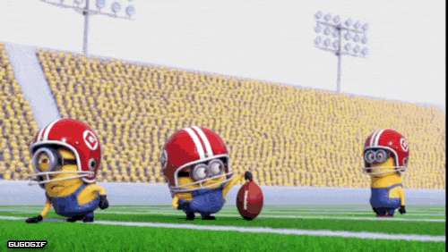 A Group Of Minions Wearing Football Helmets And Holding A Football GIF