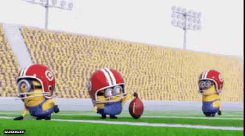 A Group Of Minions Wearing Football Helmets Are Playing A Game Of Football GIF