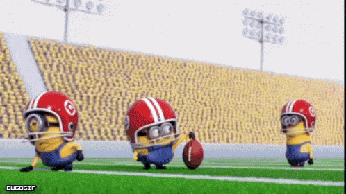 A Group Of Minions Wearing Football Helmets Are Playing Football On A Field GIF