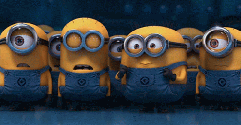 A Group Of Minions Wearing Overalls And Goggles Are Standing In A Line GIF