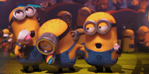 A Group Of Minions With G On Their Overalls Are Standing Together GIF