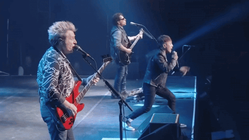 A Group Of Musicians Are On Stage With The Word Don 'T In Red GIF