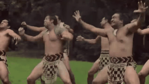 A Group Of Naked Men Are Dancing In A Field GIF