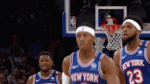 A Group Of New York Basketball Players Are Standing In Front Of A Net GIF