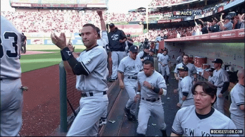 A Group Of New York Yankees Baseball Players Standing On The Field GIF