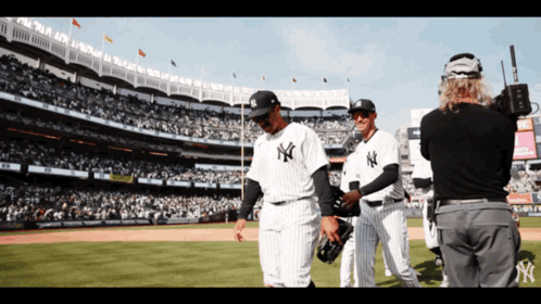 a group of new york yankees baseball players walking on the field