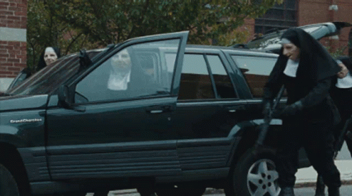 A Group Of Nuns Standing Around A Grand Cherokee GIF