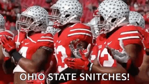 A Group Of Ohio State Football Players Are Standing In A Line . GIF