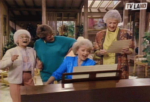 A Group Of Old Women Singing In Front Of A Tv Land Sign GIF