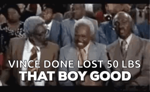 A Group Of Older Men Are Sitting In A Crowd And Laughing . GIF