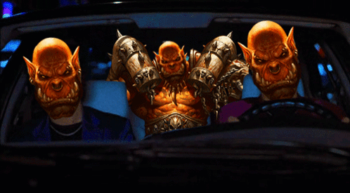 A Group Of Orcs Are Sitting In A Car With A Man In A Suit GIF