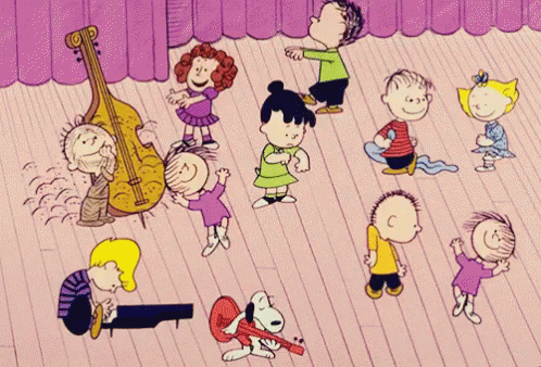 A Group Of Peanuts Characters Are Dancing On A Stage With A Purple Curtain Behind Them GIF