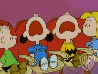 A Group Of Peanuts Characters Sitting In Red Chairs With Their Mouths Wide Open GIF