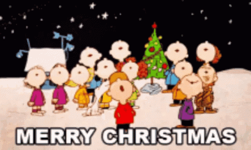 A Group Of Peanuts Characters Standing In Front Of A Christmas Tree With The Words Merry Christmas Above Them GIF