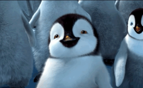 A Group Of Penguins Are Standing In The Water And One Of Them Is Smiling GIF