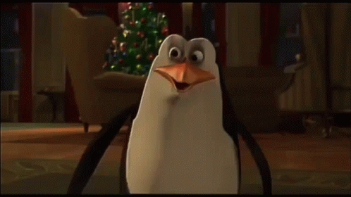 A Group Of Penguins Standing Next To Each Other With Their Beaks Open GIF