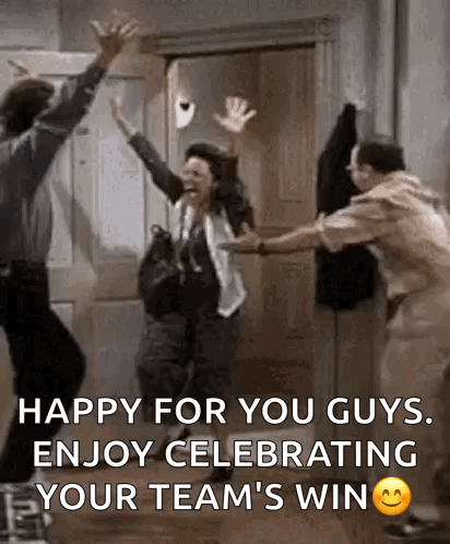 A Group Of People Are Celebrating A Team 'S Win In A Room . GIF
