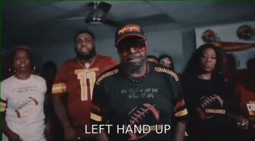 A Group Of People Are Cheering With The Words " The Commanders " Written On The Bottom GIF