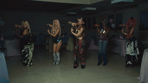 A Group Of People Are Dancing At A Party With A Bag That Says Hawaii On It GIF