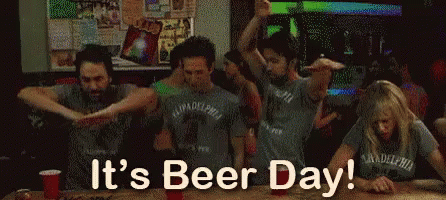 A Group Of People Are Dancing In A Bar And The Words It 'S Beer Day Are Above Them GIF