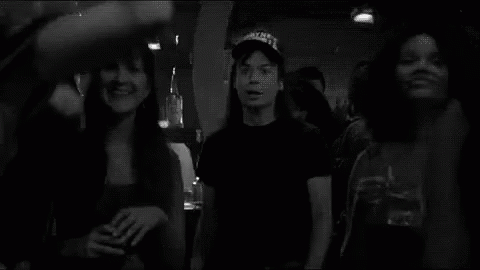 A Group Of People Are Dancing In A Black And White Photo With Schwing Written In White GIF