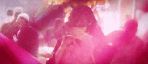 A Group Of People Are Dancing In A Club With Pink Smoke Coming Out Of The Ceiling . GIF