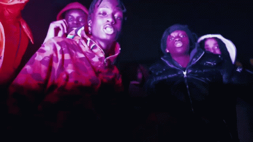 A Group Of People Are Dancing In A Dark Room And One Of Them Is Wearing A Jacket That Says Moncler On It GIF