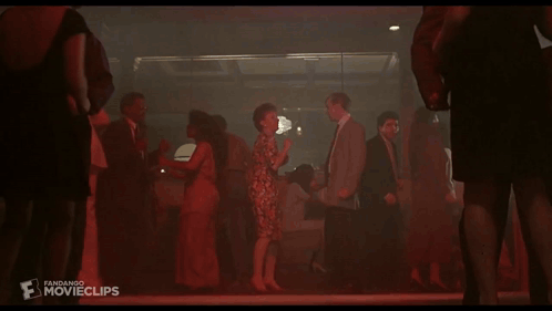 A Group Of People Are Dancing In A Dark Room And The Word Movieclips Is On The Bottom Right GIF