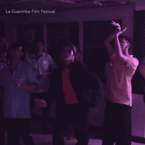 A Group Of People Are Dancing In A Dark Room And The Words La Guarimba Film Festival Are Above Them GIF
