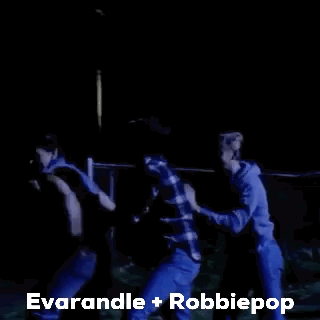A Group Of People Are Dancing In A Dark Room With The Words Everandle + Robbiepop Written Above Them . GIF