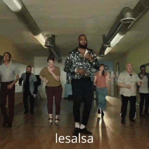 A Group Of People Are Dancing In A Hallway And The Word Lesalsa Is On The Bottom Right GIF