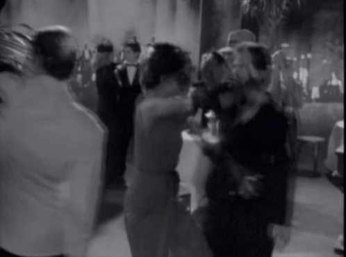 A Group Of People Are Dancing In A Room GIF