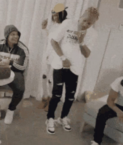 A Group Of People Are Dancing In A Room And One Of Them Is Wearing A Shirt That Says ' Loud ' On It GIF