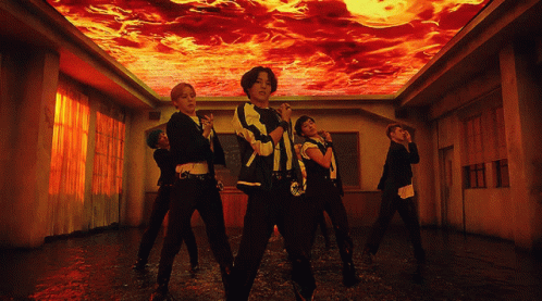 A Group Of People Are Dancing In A Room With A Ceiling That Is On Fire GIF