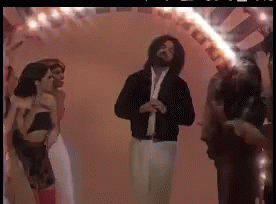 A Group Of People Are Dancing In A Room With A Fire Coming Out Of Their Mouths GIF