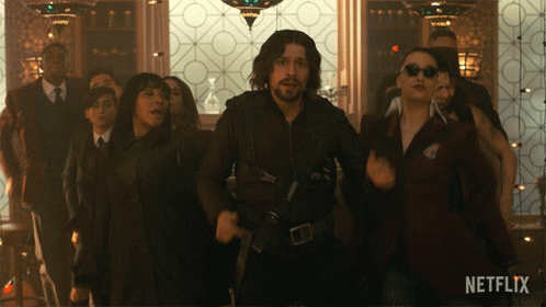 A Group Of People Are Dancing In A Room With A Netflix Logo On The Bottom GIF