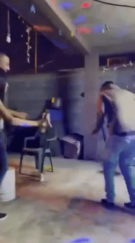 a group of people are dancing in a room with a sign that says " a " on it
