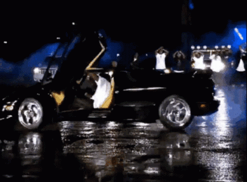 A Group Of People Are Dancing In Front Of A Car That Says Limousine GIF