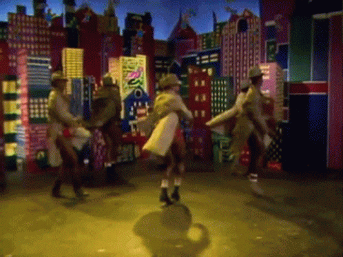 a group of people are dancing in front of a cityscape with a sign that says disco