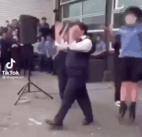 A Group Of People Are Dancing In Front Of A Crowd . GIF
