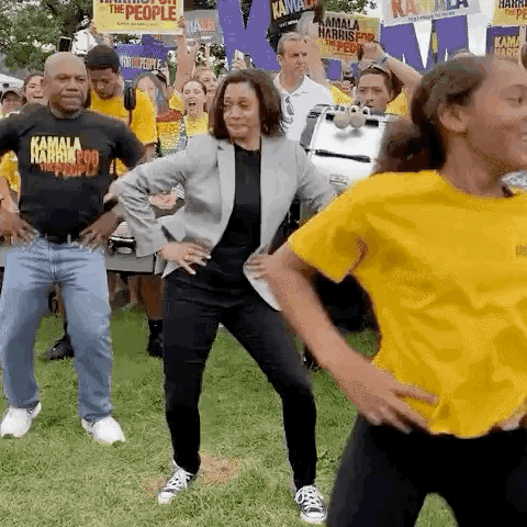 A Group Of People Are Dancing In Front Of A Crowd Of People . GIF