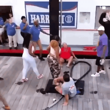 A Group Of People Are Dancing In Front Of A Harr Sign GIF