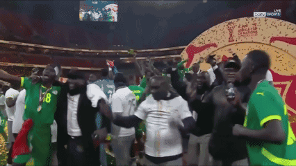 a group of people are dancing in front of a screen that says sky sports
