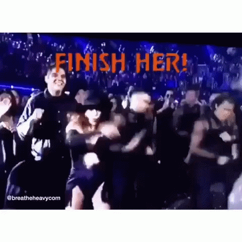 A Group Of People Are Dancing In Front Of A Sign That Says Finish Her . GIF